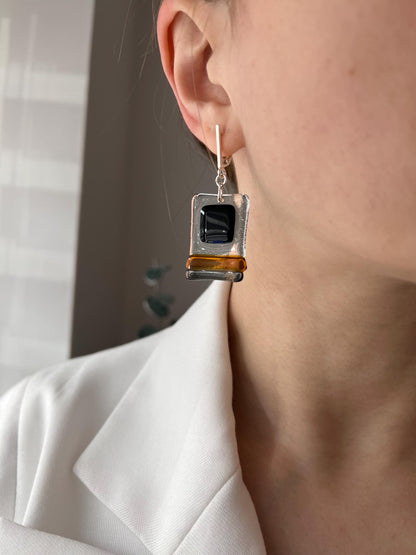 Modern fused glass earrings with sterling silver hooks, featuring geometric rectangular design in contrasting glossy black and amber brown tones