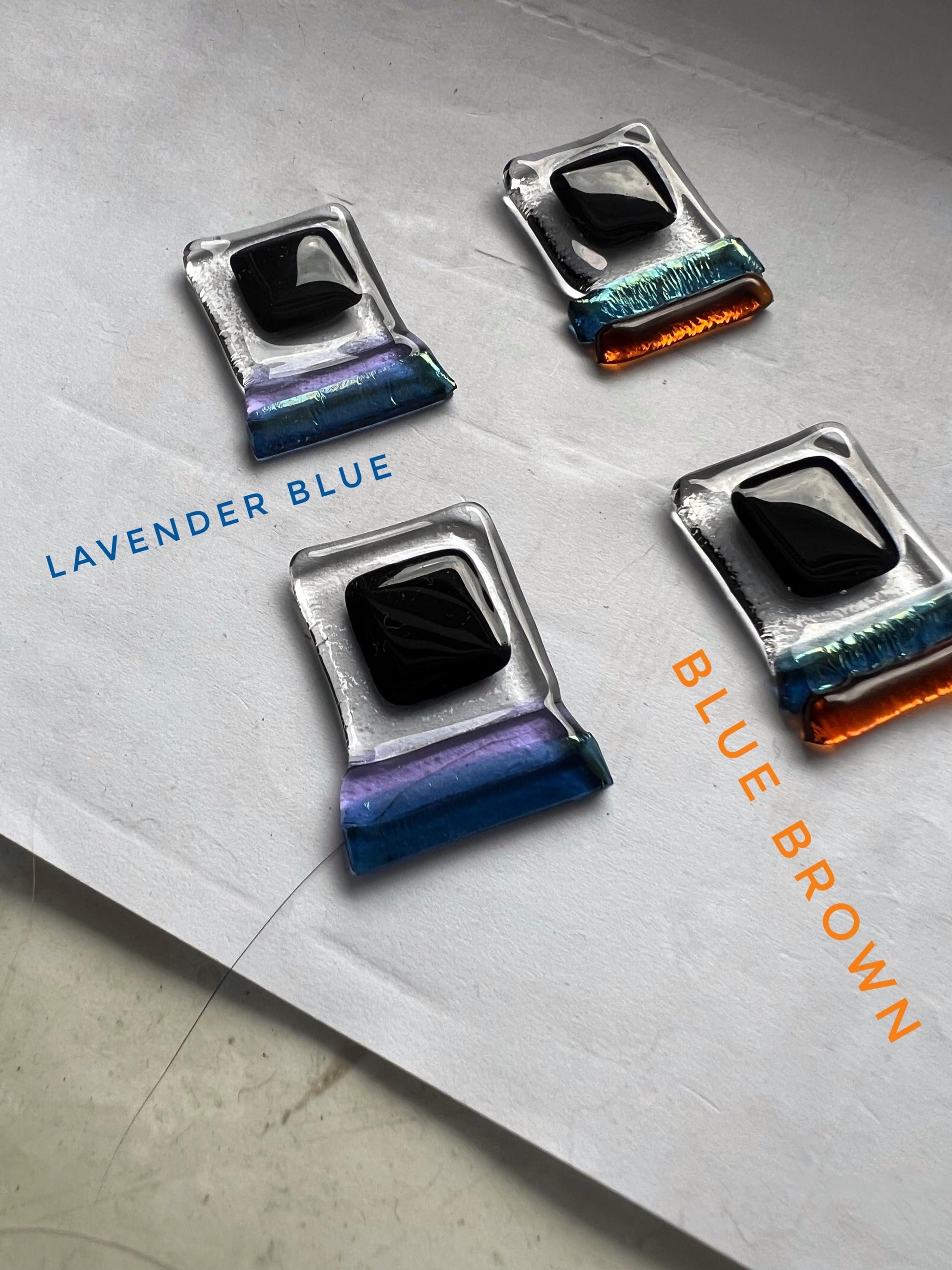 A collection of rectangular earrings handmade from glass using the fusing technique. Products in rich shades: black, turquoise, amber, transparent, dark blue, light brown, lavender blue.. Each pair is unique, hand-crafted with silver fittings. choose the ones you like the most