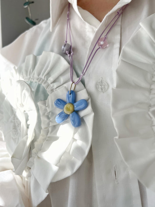 blue fused glass flower necklace on model