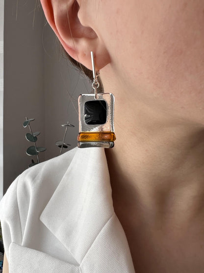 Modern fused glass earrings with sterling silver hooks, featuring geometric rectangular design in contrasting glossy black and amber brown tones