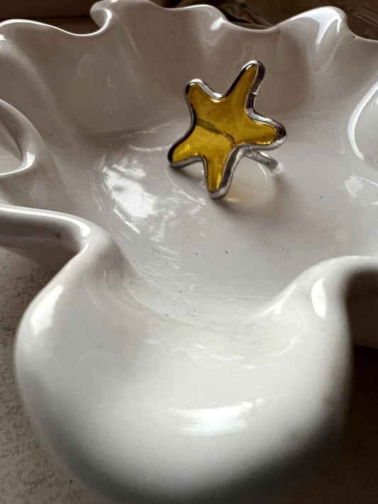 Handmade stained glass ring shaped like a starfish. Ocean-inspired statement jewelry in orange tones.