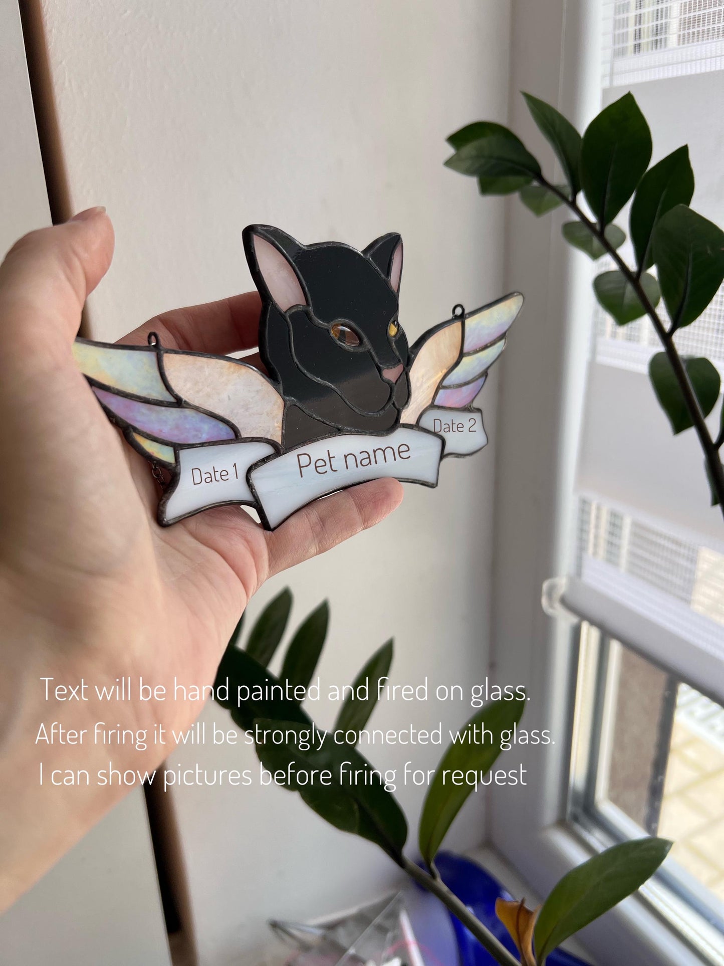 Hand holding the stained glass cat ornament – size reference for jewelry.