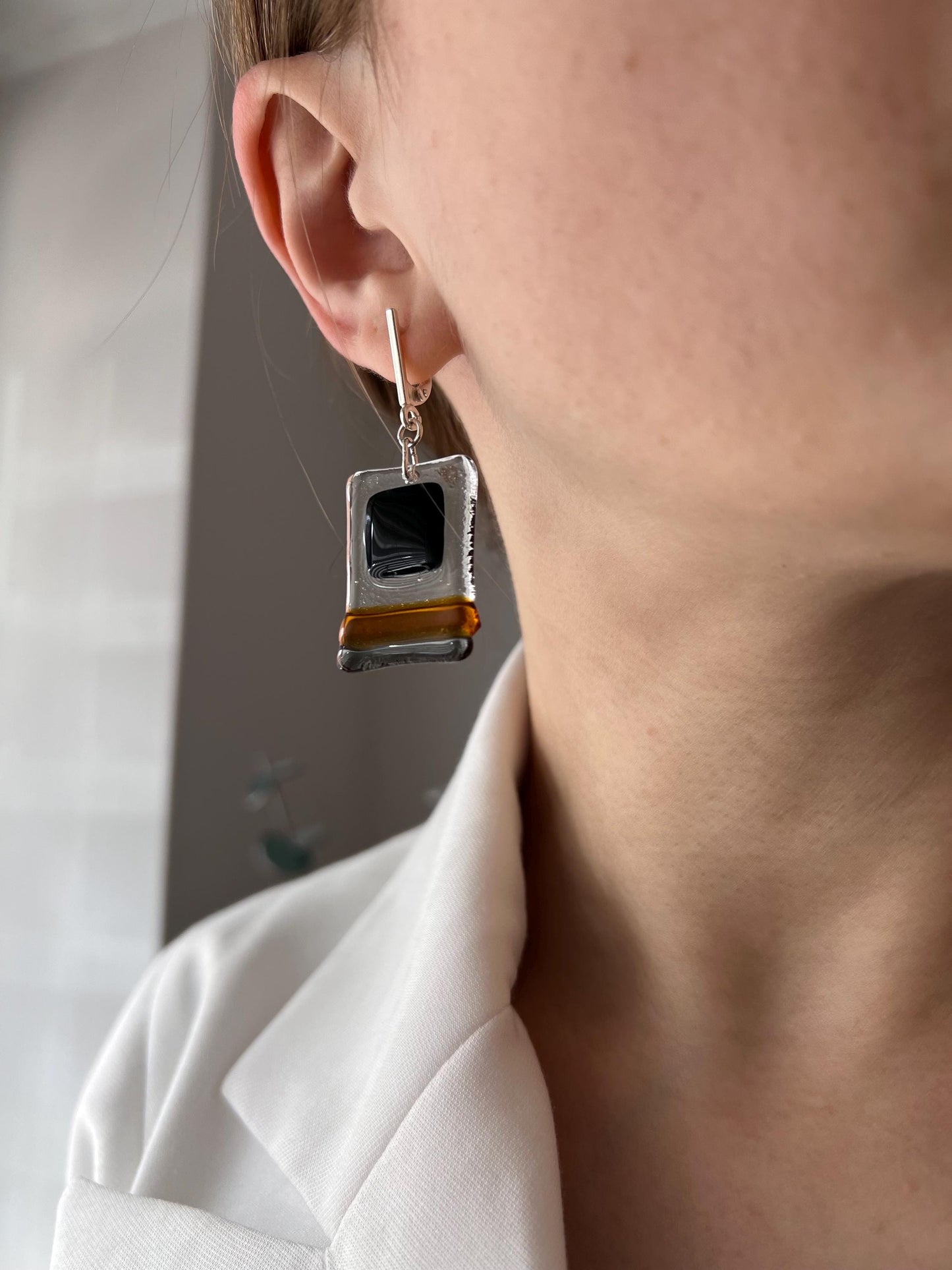 Modern fused glass earrings with sterling silver hooks, featuring geometric rectangular design in contrasting glossy black and amber brown tones