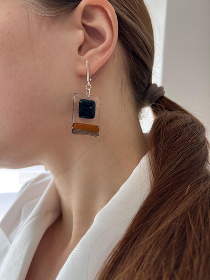 Modern fused glass earrings with sterling silver hooks, featuring geometric rectangular design in contrasting glossy black and amber brown tones