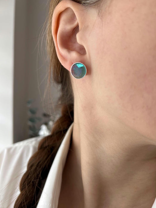 Glossy green-blue fused glass stud earrings with sterling silver 925 posts. Small, round, candy-like shape. Handmade using fusing technique. Modern dainty jewelry gift for her.