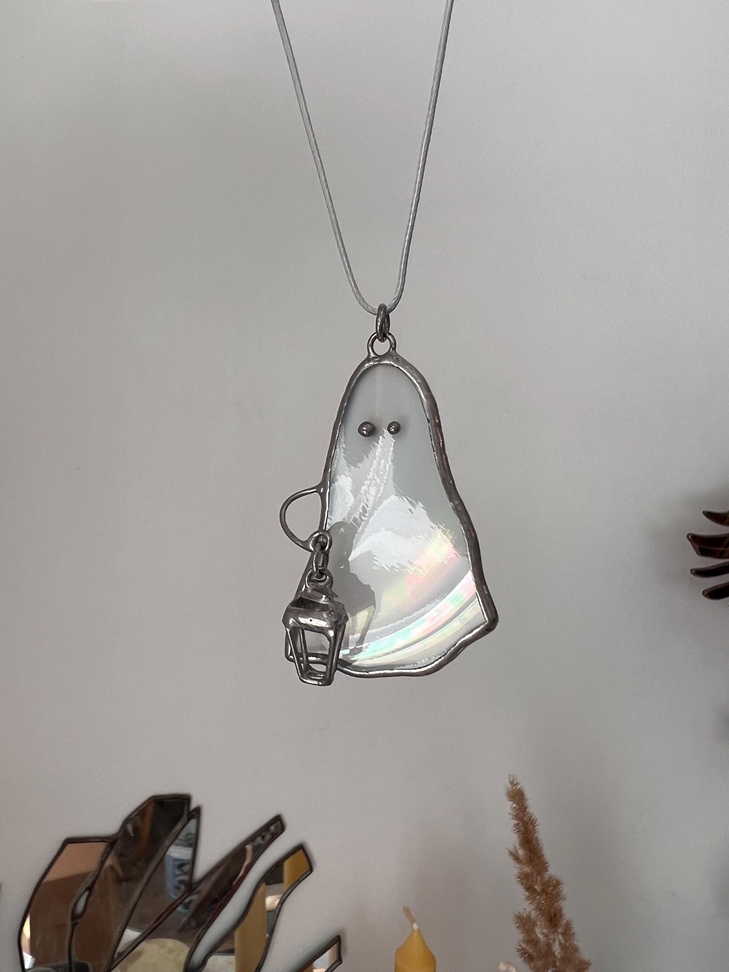 Cute spooky Halloween necklace made of white iridescent glass shaped like a ghost