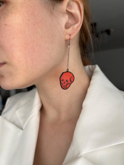 Red glass skull earring worn, spooky minimalist gothic style jewelry