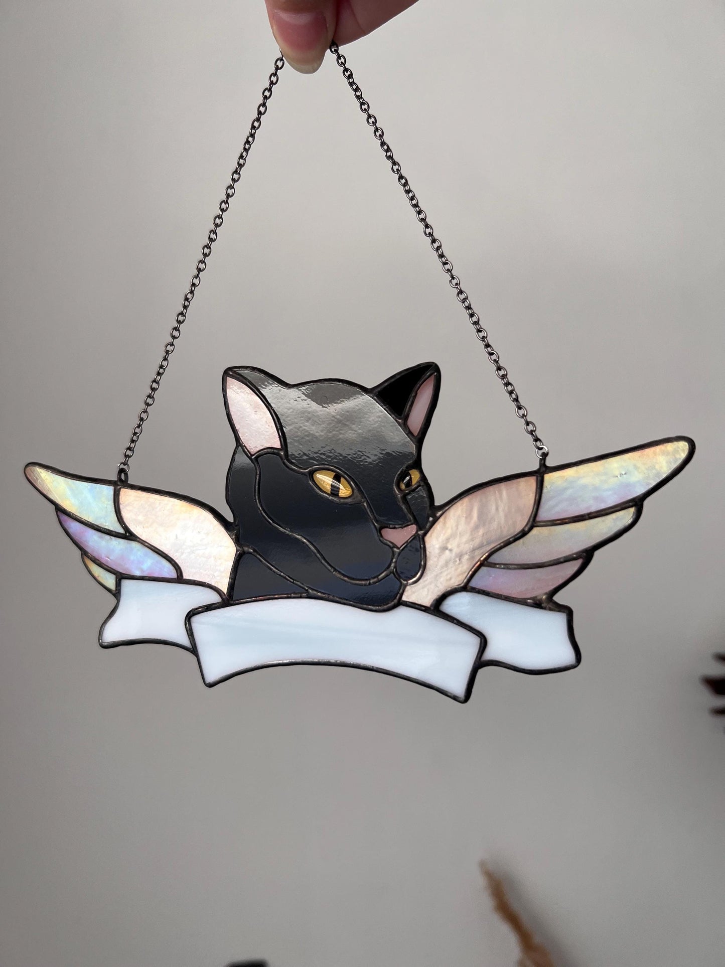 Handmade stained glass cat tribute against neutral background