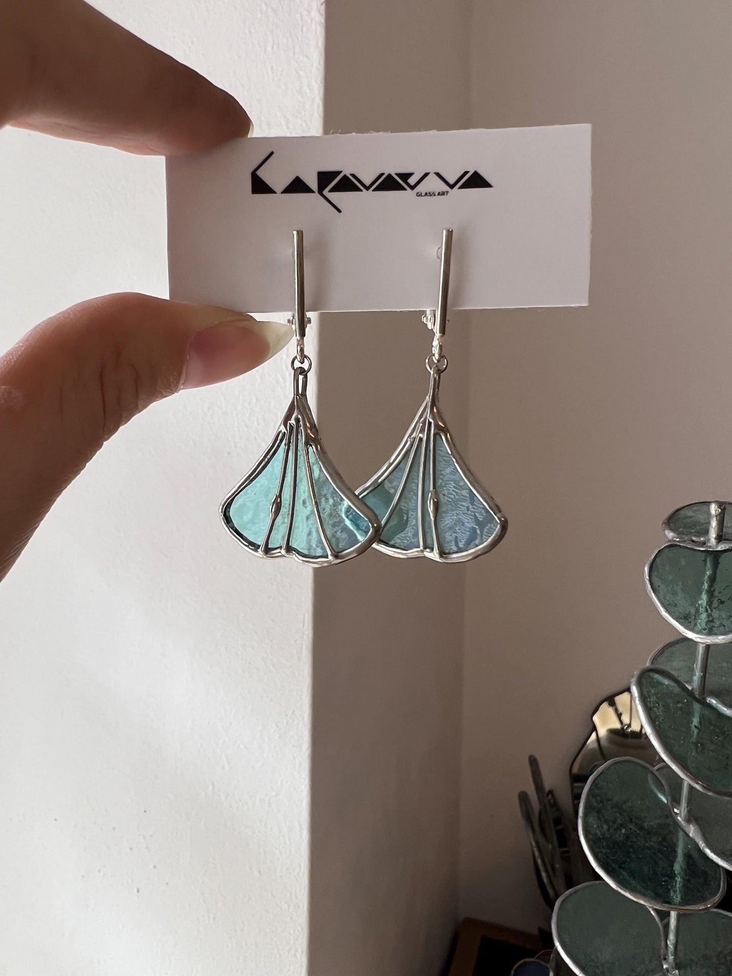 Handmade stained glass earrings in mint green shaped like ginkgo leaves, botanical nature-inspired jewelry, elegant dangle design