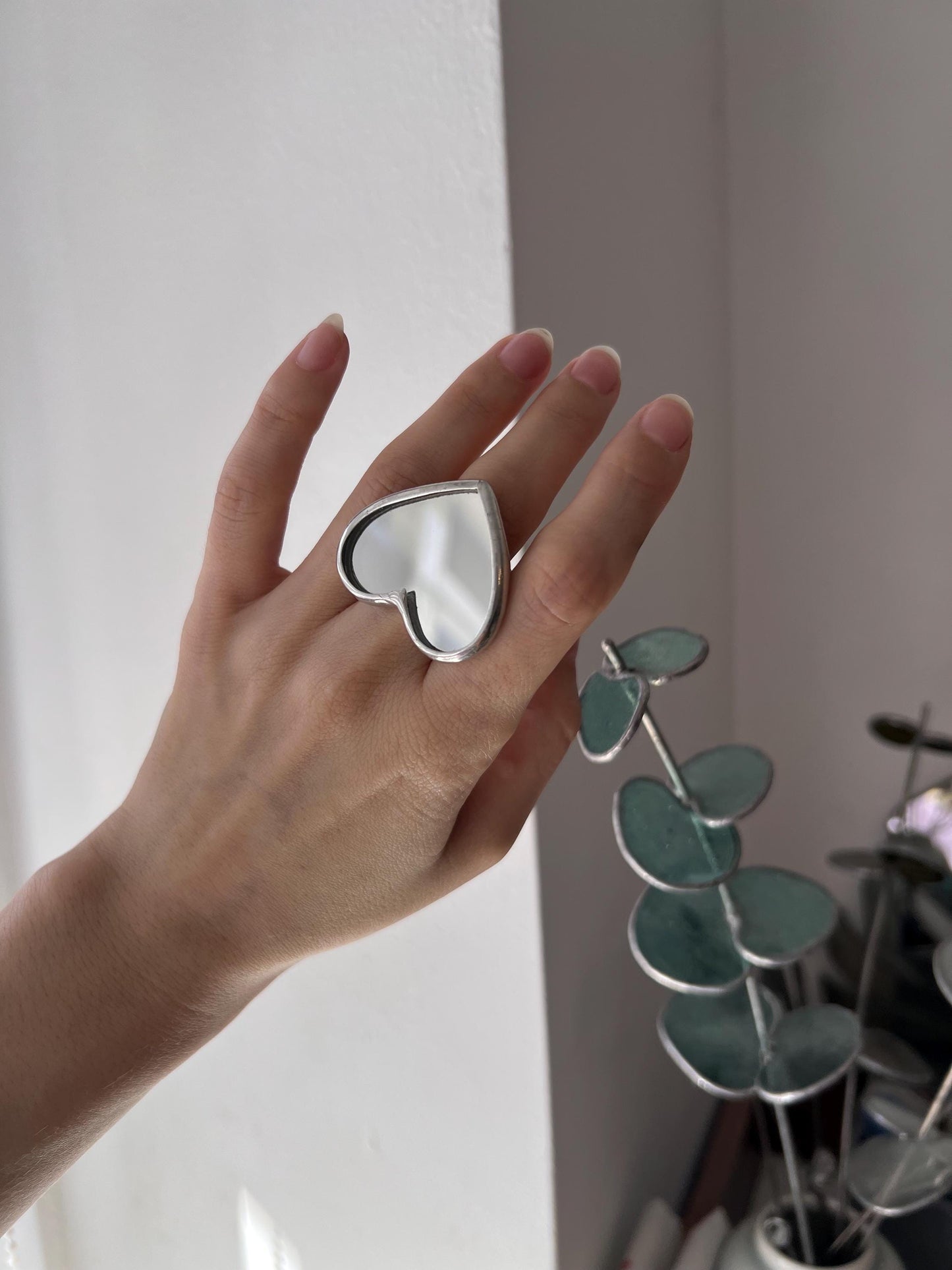Chunky statement heart ring on the model's hand