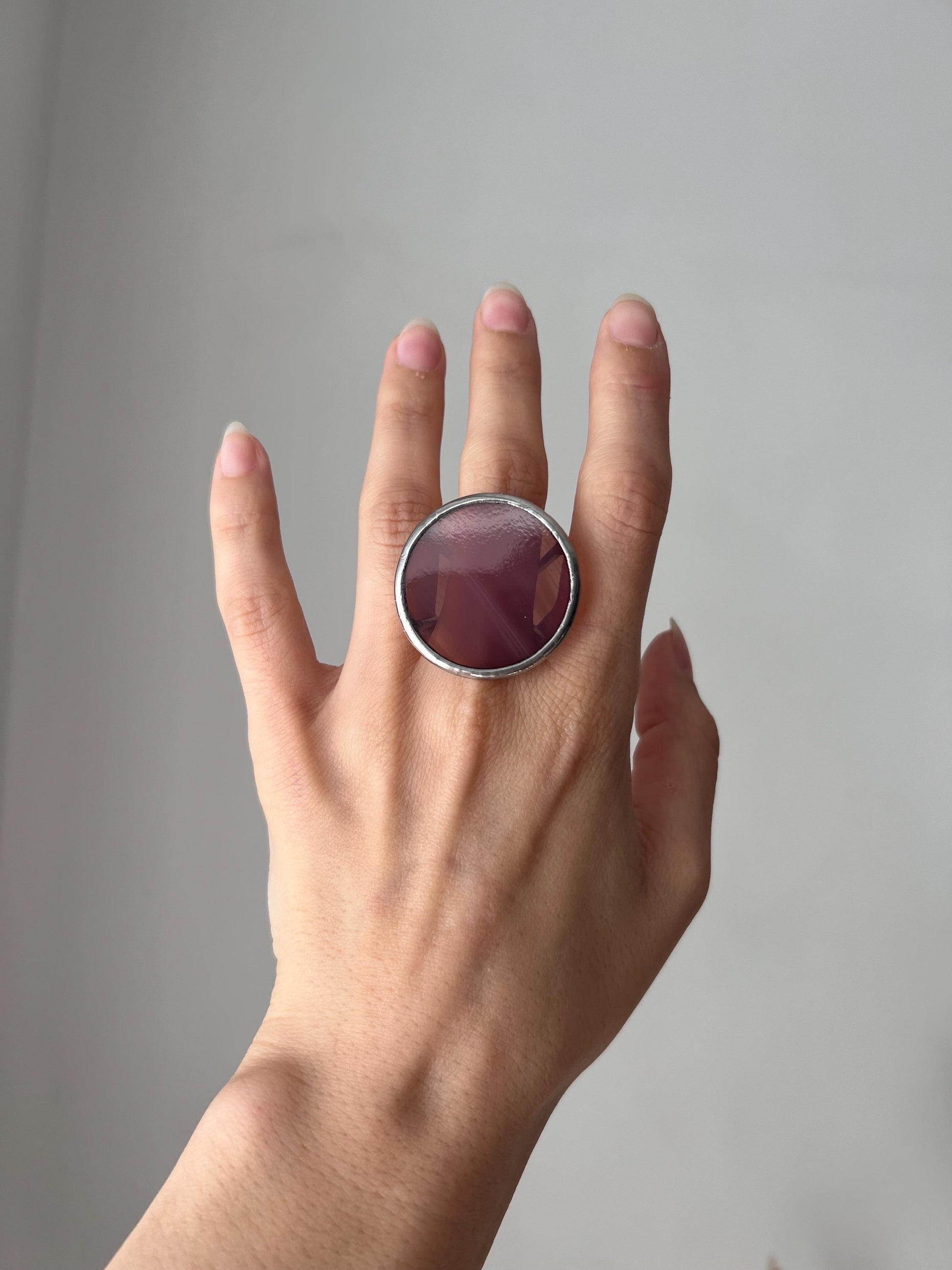 Purple plum glass ring worn outdoors