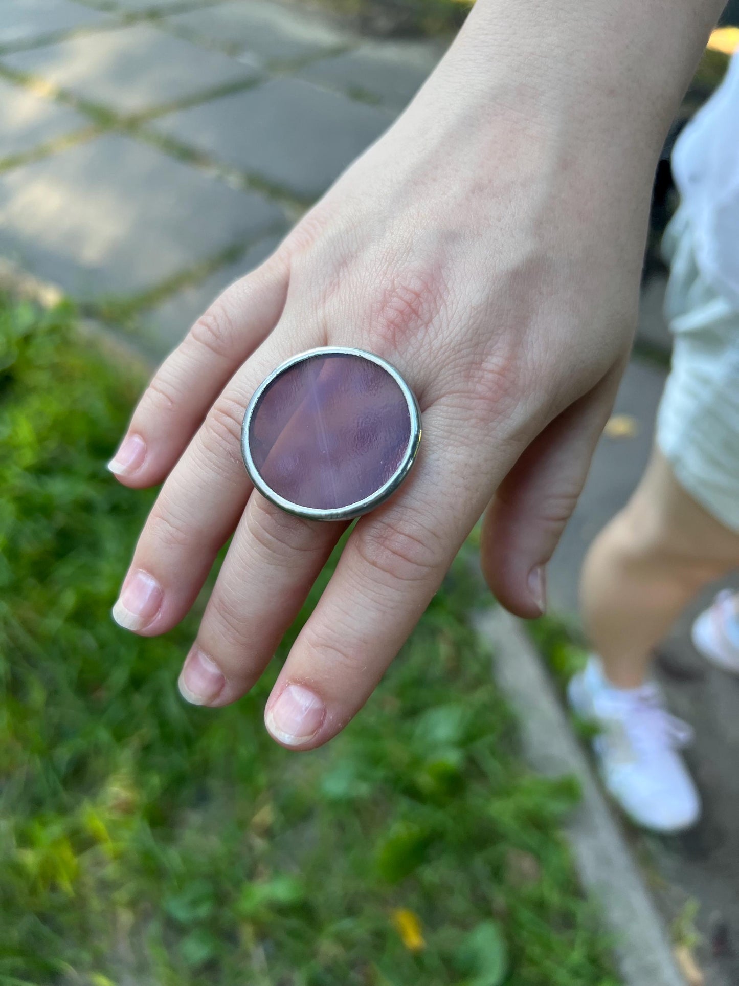 Artistic plum glass ring shown in natural light