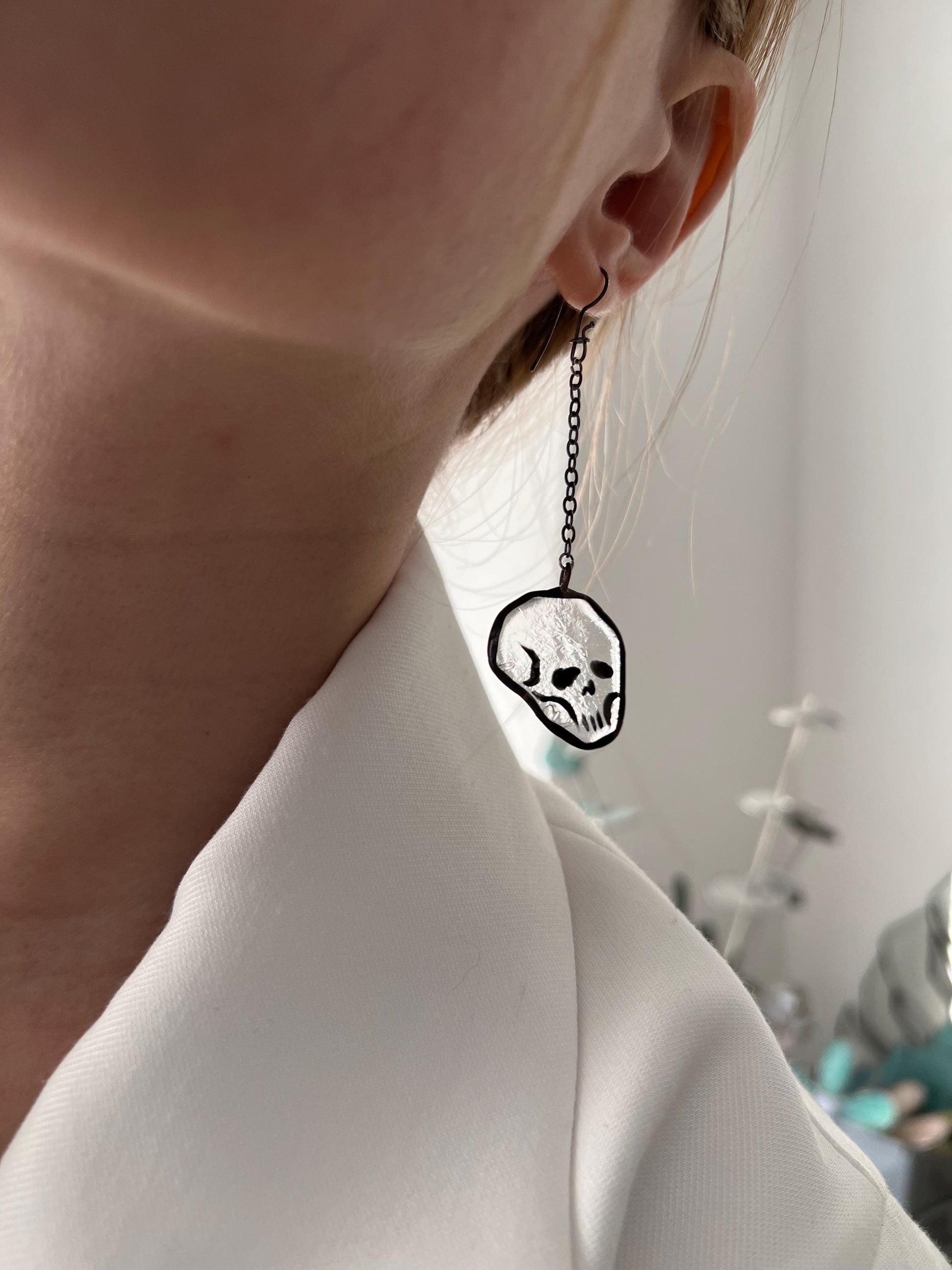 Transparent skull earrings side view, handmade gothic glass jewelry