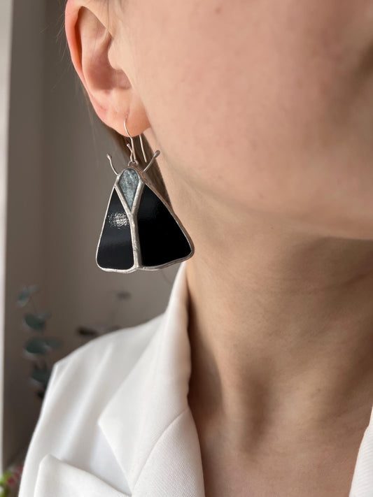 Black stained glass butterfly earrings close up on white background