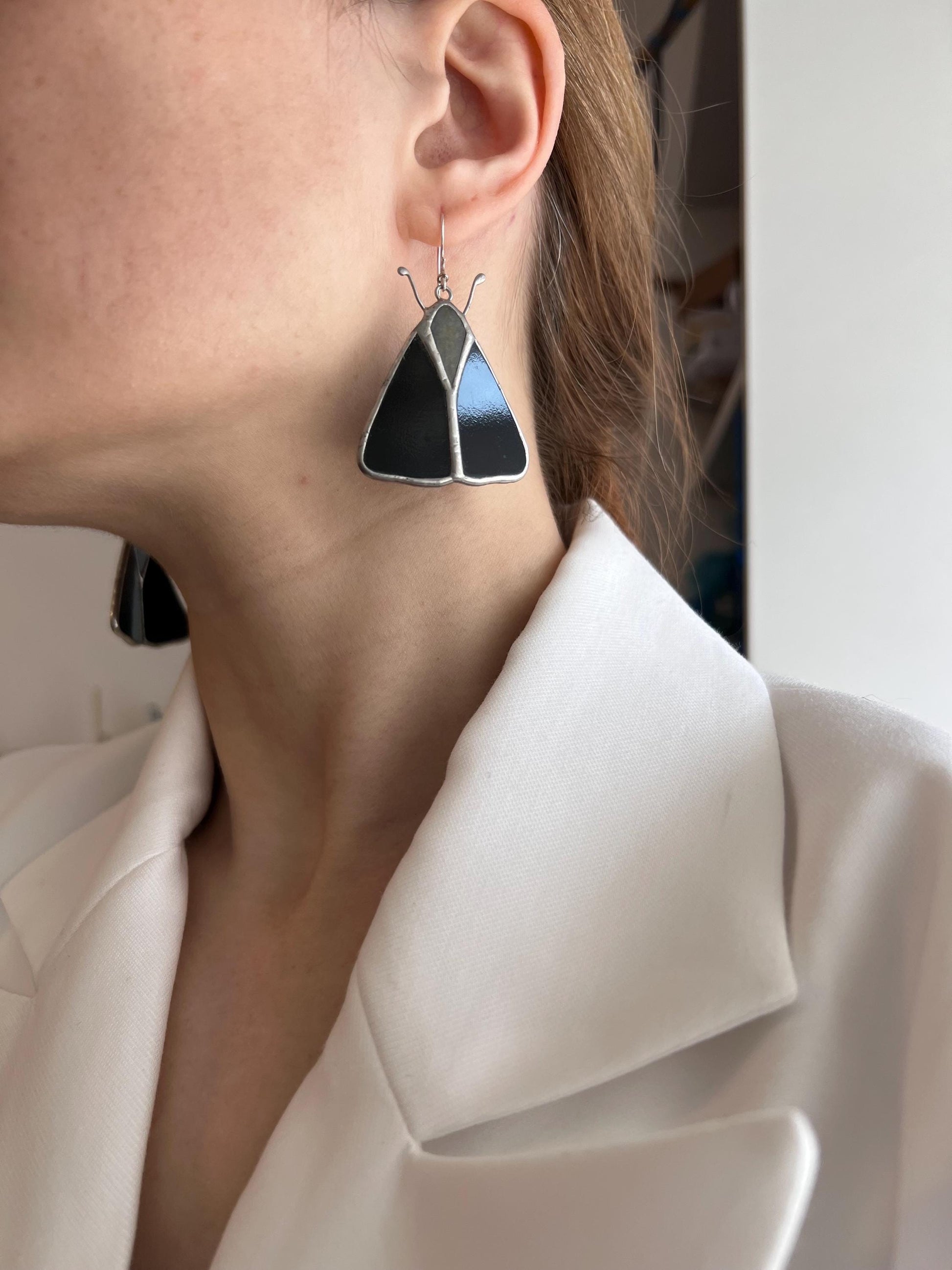 Close up of stained glass moth earrings gift idea
