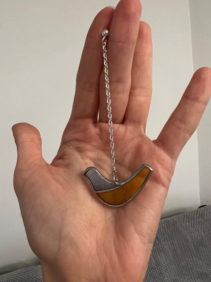 stained glass bird pendant necklace in hand