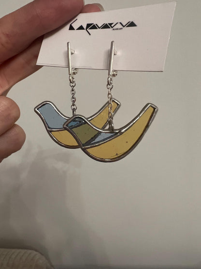 Blue and yellow stained glass bird earrings close up
