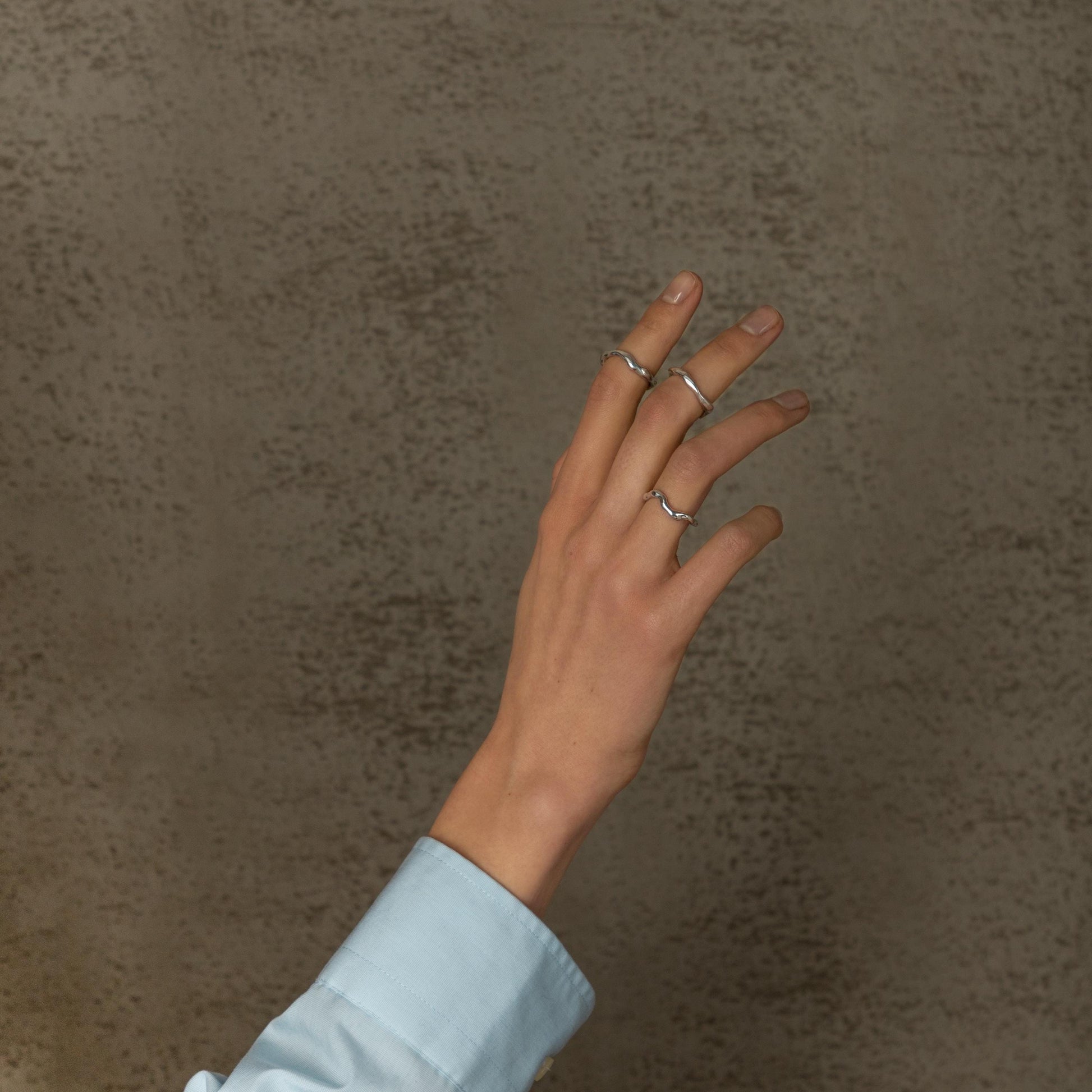 Sterling silver wave ring on hand, minimalist organic jewelry design