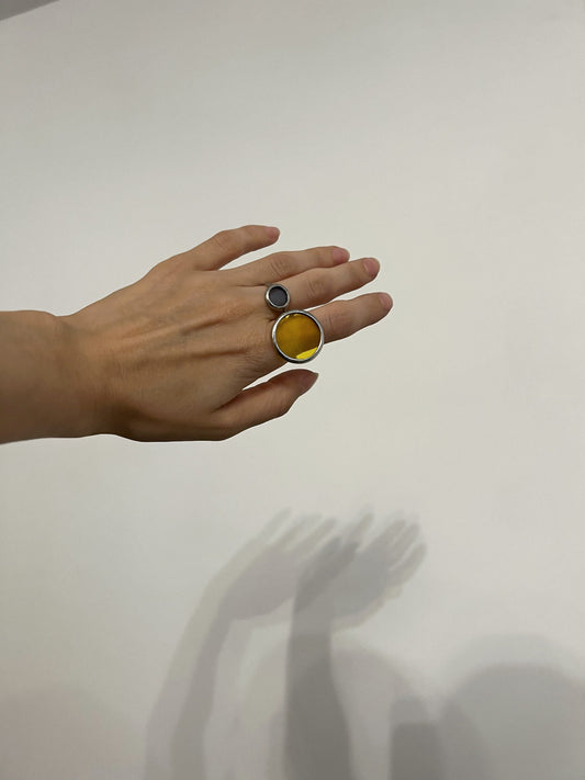 Handmade stained glass ring set featuring a small light blue circle ring and a larger yellow glass disk ring designed as modern geometric jewelry. These unique friendship rings can be worn as couple rings for girlfriends or sisters, symbolic stained glass statement jewelry for bridesmaids or best friends. The minimalist geometric style makes them elegant women gifts, chic roommate presents, and meaningful accessories that combine blue and yellow glass art with delicate round forms.