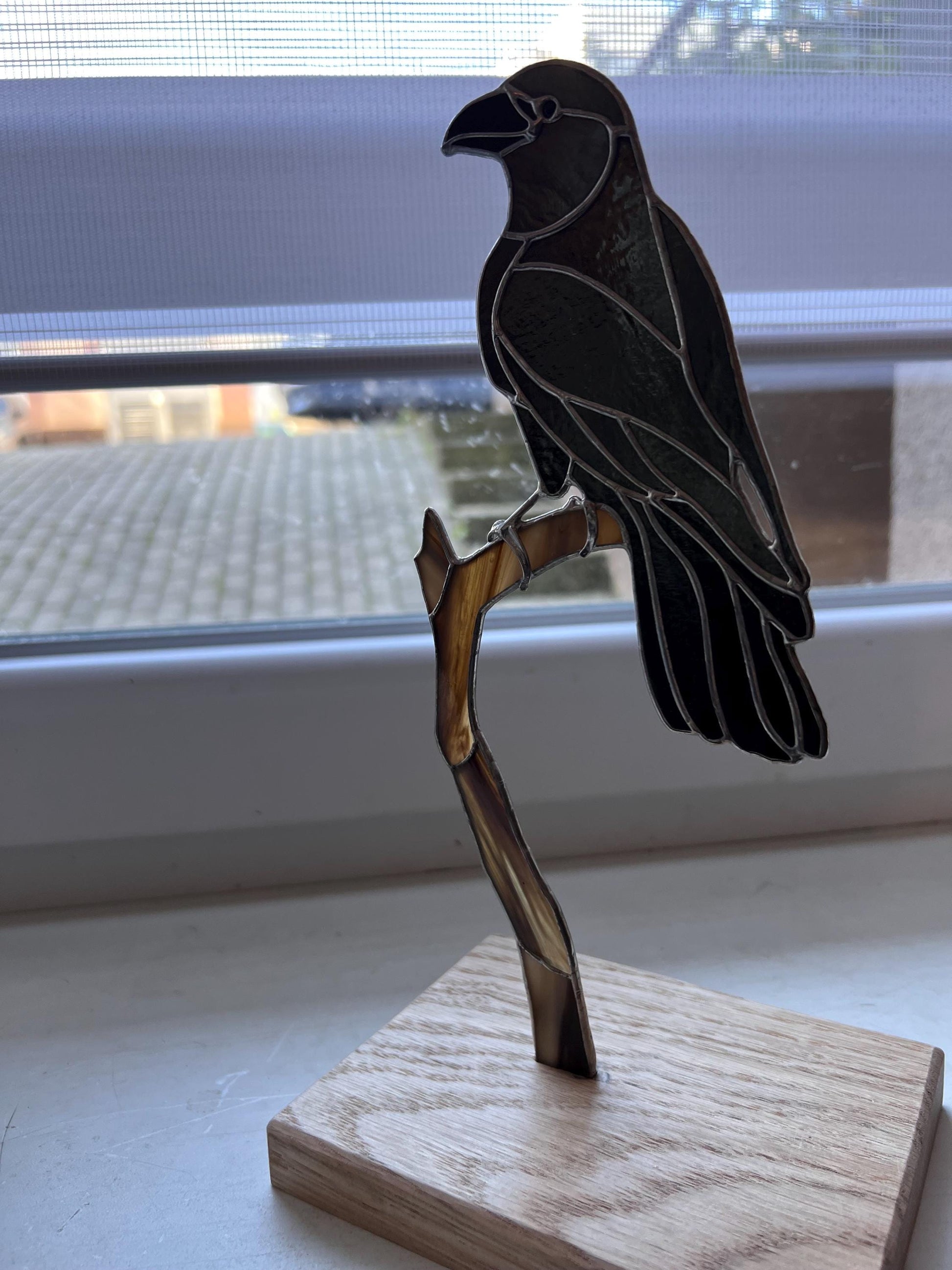 Black stained glass crow decor standing on window shelf – bird lover gift