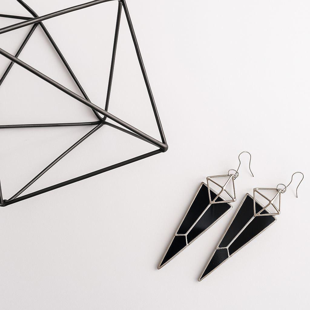 Dramatic statement earrings with occult vibe