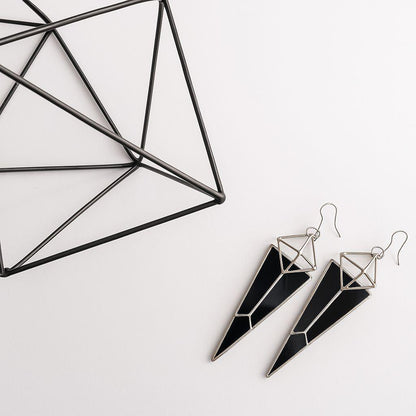 Dramatic statement earrings with occult vibe