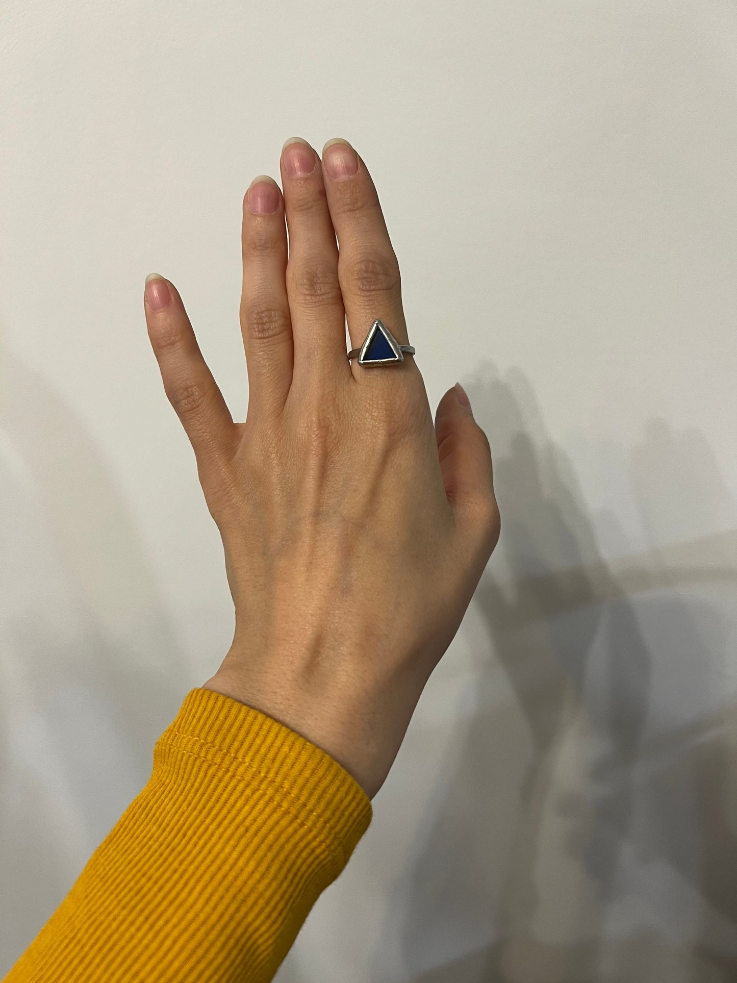Artistic disc style ring in deep blue glass. Blue stained glass triangle ring on hand – bold geometric jewelry. Handmade stained glass ring – bold blue accessory for her.