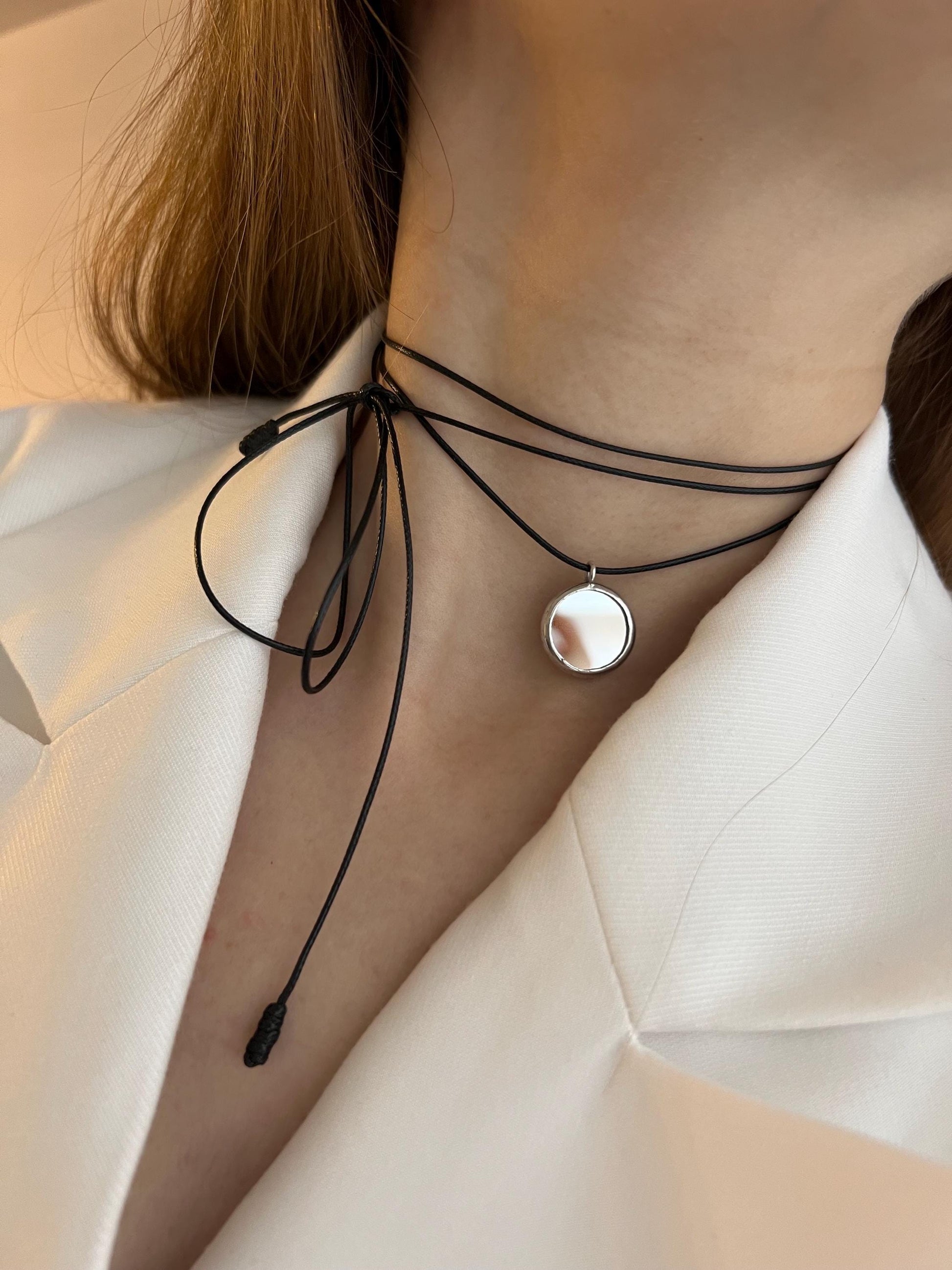 Black cord mirror choker styled with white blazer