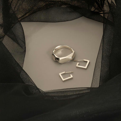 sculptural silver stud earrings on black fabric