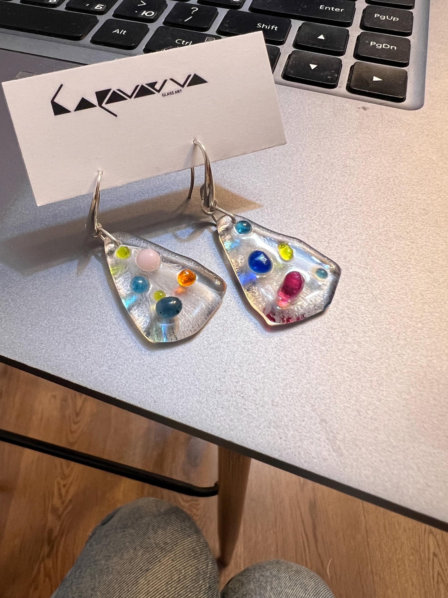 Earrings shown near window light highlighting glass transparency