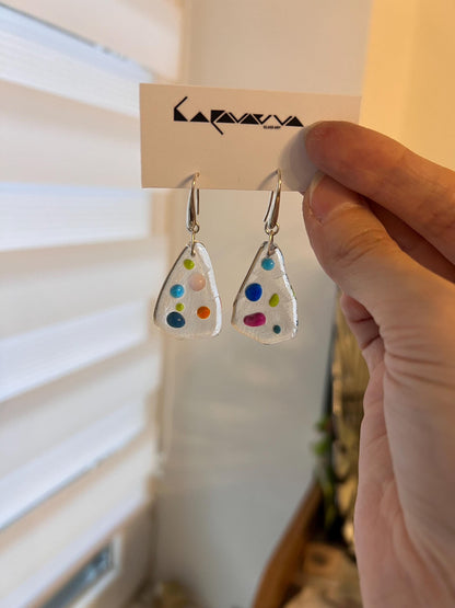 Handmade glass earrings displayed on branded card