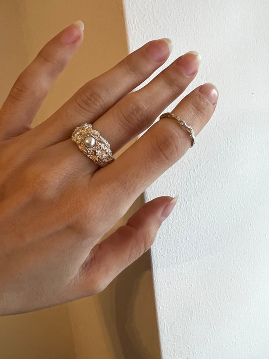 Textured sterling silver pearl dome ring on woman’s finger