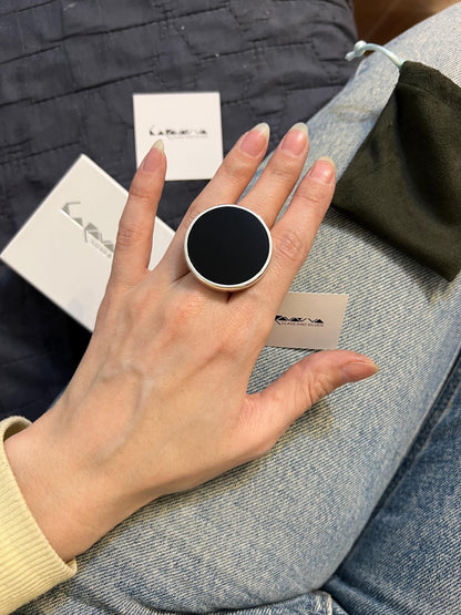 Black opal glass ring on hand, contemporary sterling silver statement ring