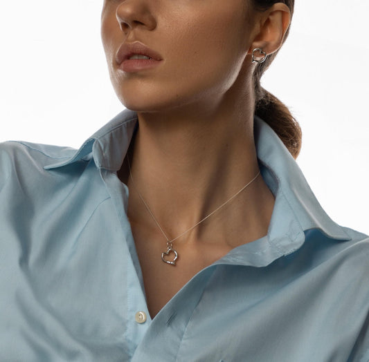Model wearing silver heart pendant on nylon cord choker — elegant minimalist jewelry for women