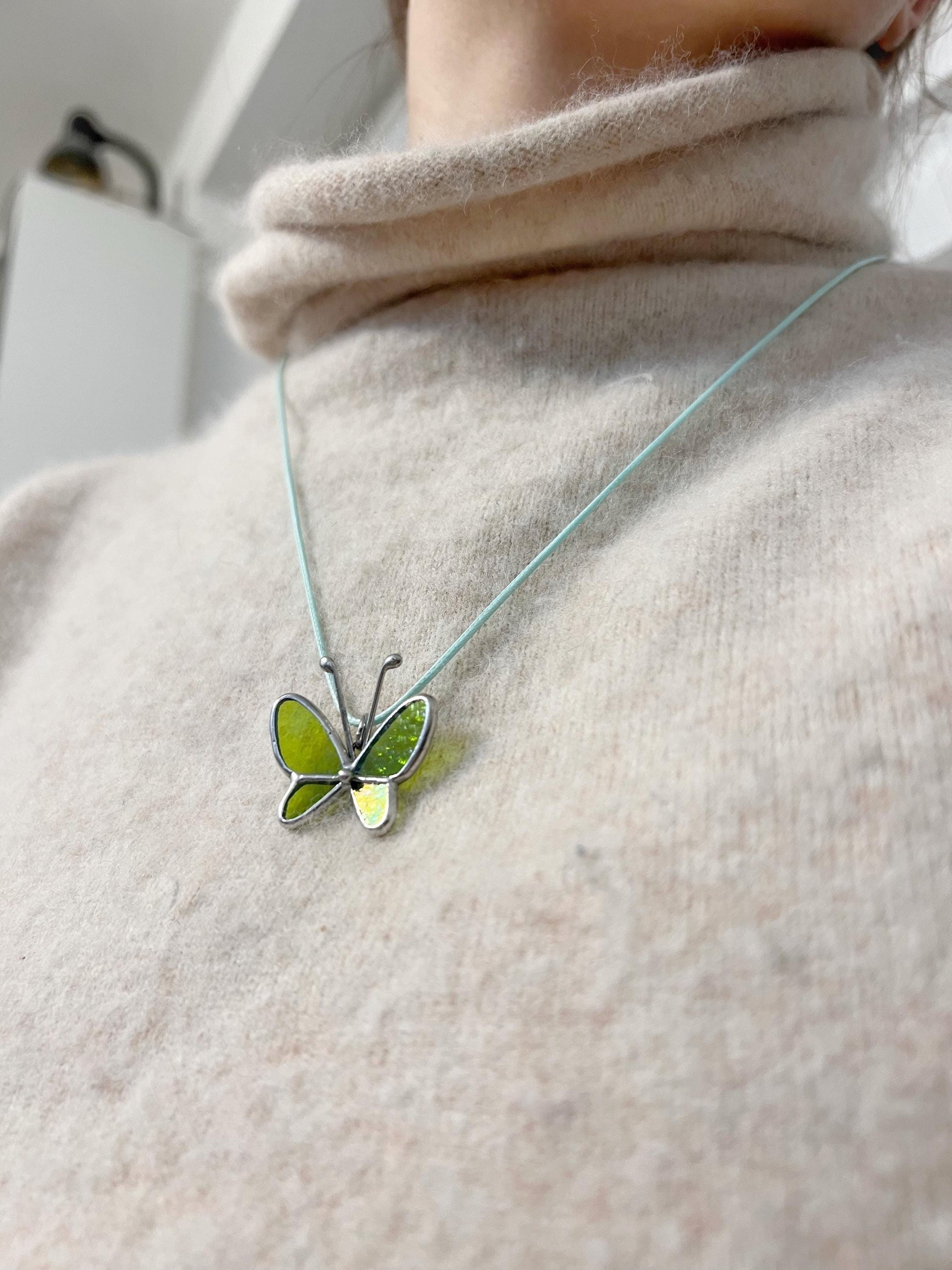 Stained glass butterfly necklace on model, fairy nature pendant