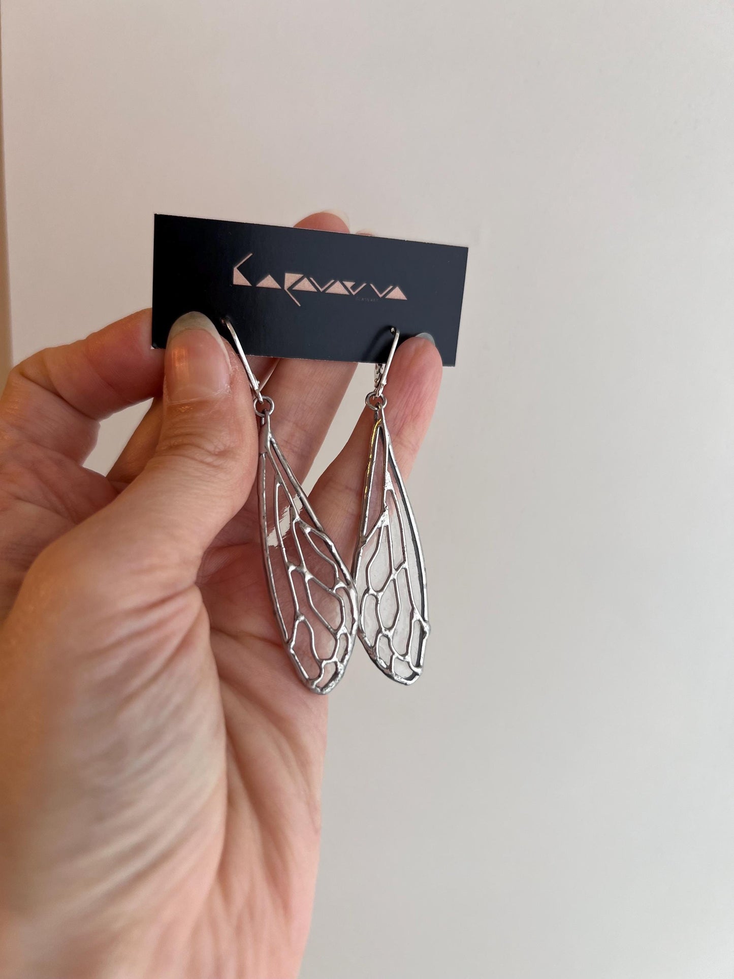 size reference cicada wing earrings in hand