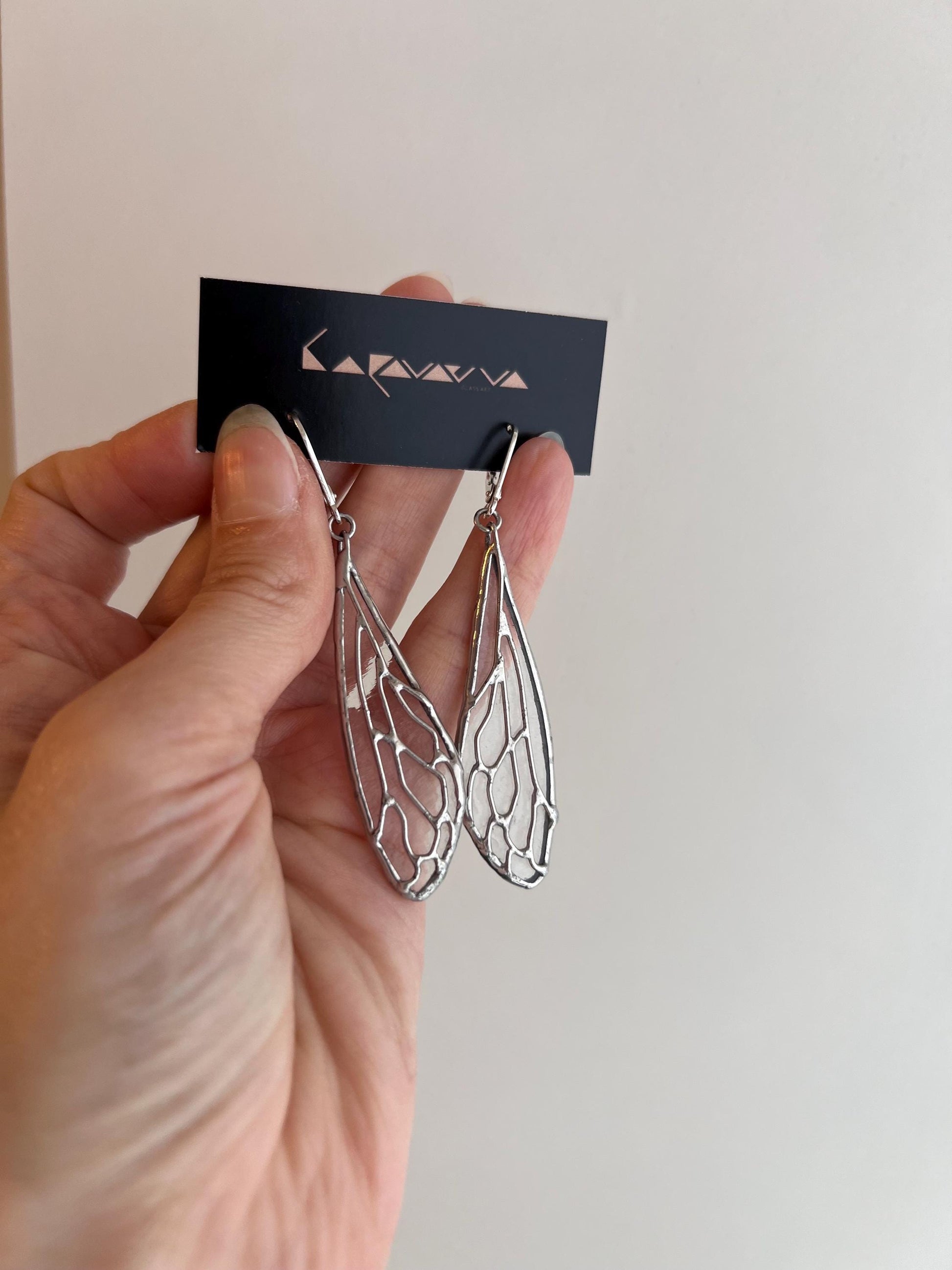 size reference cicada wing earrings in hand